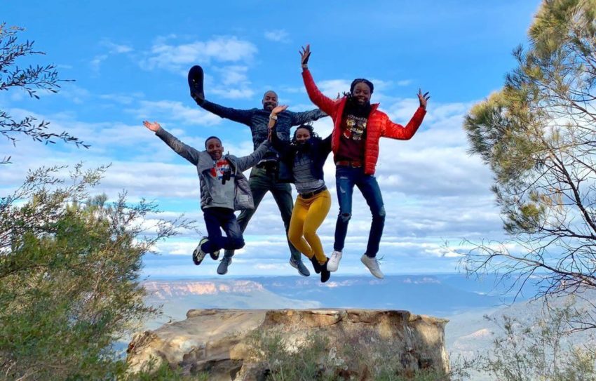 People jump off a rock in the Blue Mountains